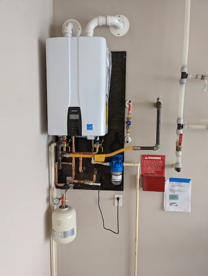 Professional plumber installing copper piping in a Frontenac home